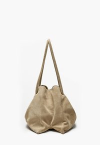 Beige suede shoulder bag with two long straps and a soft, rounded, slightly wrinkled body on a white background.