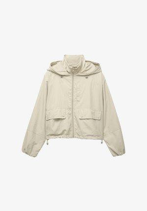 Ljust beige kort jacka, tillverkad av lätt material, med dragkedja framtill, huva, två framsidor fickor och justerbara dragsnören vid fållen.