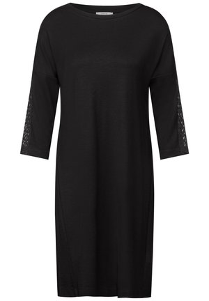 Sort tunika-kjole med trekvartærmer, der har teksturerede blonderpaneler på ærmerne. Fremstillet af blødt, letvægtsstof.