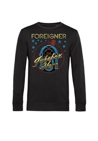 Felpa nera con stampa grafica che presenta un design di jukebox, il testo "FOREIGNER" e "Jukebox Hero," accentuato da stelle blu.