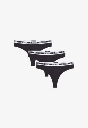 Tres tangas negras de mujer con cinturillas blancas que muestran repetidamente el logo G-STAR en letras negras.