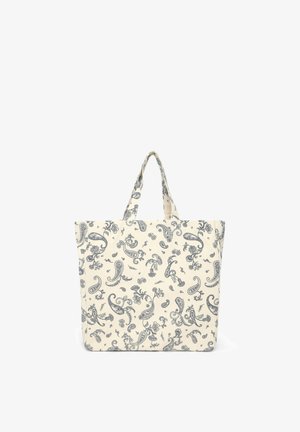Borsa tote in cotone con motivo paisley blu navy su sfondo crema. Presenta due manici corti e una forma rettangolare.