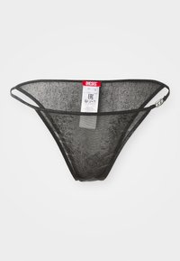 Svart mesh-tanga med tynne elastiske stropper, med et merkelapp som har merkenavnet 'Diesel.' Teksturliknende stoff og design med minimal dekning.