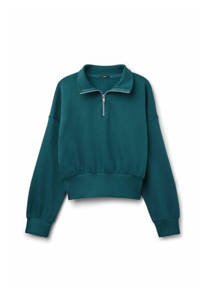 Sudadera corta de color verde azulado, fabricada en un tejido suave. Presenta un cuello con cremallera y puños acanalados, con un corte relajado y un diseño minimalista.