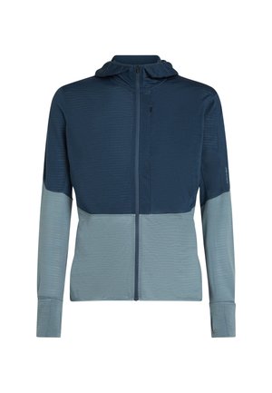 Huvjacka i mörk marinblått och ljusblått, med strukturerat tyg, dragkedjestängning och åtsittande ärmar. Tvåfärgad design med slät finish.