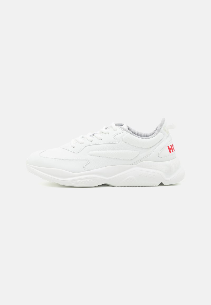 White athletic shoe with textured upper, lace-up design, padded collar, and a pink "HUGO" logo on the heel. Cushioned sole for comfort.