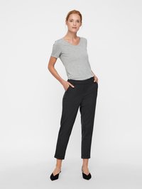 Gray short-sleeve t-shirt paired with black tailored pants. The pants feature a smooth texture, tapered legs, and cuffed hems.