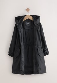 Veste légère noire avec capuche, poignets élastiques et taille ajustable. Comprend deux poches latérales et une fermeture éclair sur toute la longueur.