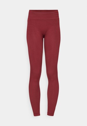 Leggings bordeaux con una vita alta e strutturata, design aderente e texture del tessuto liscia. Nessun motivo visibile o dettagli hardware.