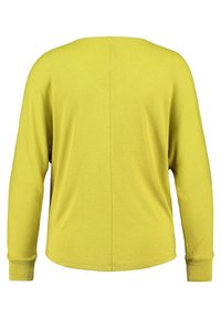 Long-sleeve mustard yellow sweater with a seam running vertically down the back and ribbed cuffs on each sleeve.