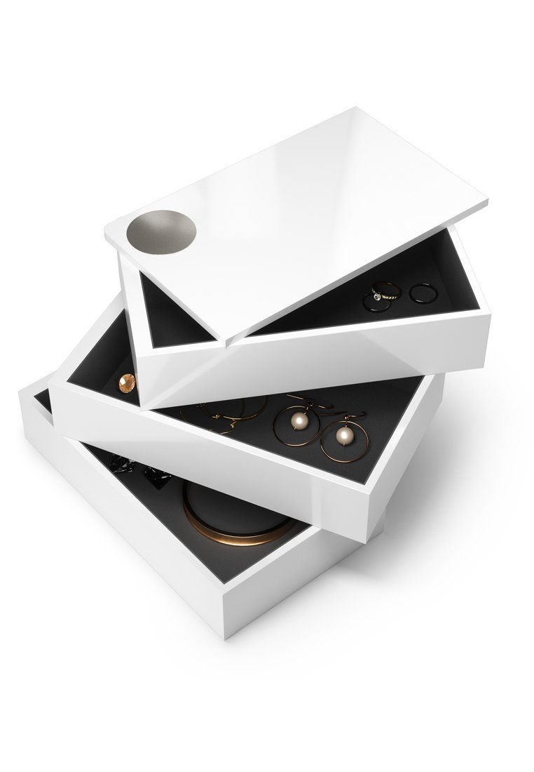 Cajas de joyería blancas apiladas con un acabado brillante, mostrando interiores oscuros que contienen pendientes de oro y plata, anillos y una pulsera.