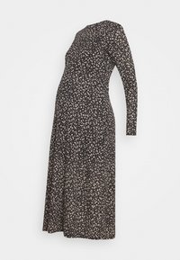 Mustakynsi musta raskaustunika pitkilla hihoilla, jossa on beige abstrakti kuvio. Valmistettu pehmeästä, joustavasta kankaasta ja suunniteltu mukavuutta silmällä pitäen.