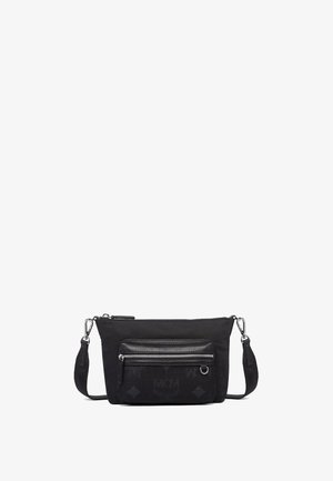 Zwarte stoffen schoudertas met een gladde afwerking, voorzien van een voorzak met rits, een verstelbare schouderband en een logo-detail aan de voorkant.