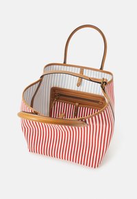 Pruhovaná taška na rameno s červenobílým vnějškem, rukojeti z hnědé kůže, modrobílě pruhovanou podšívkou a vnitřní kapsou na zip.