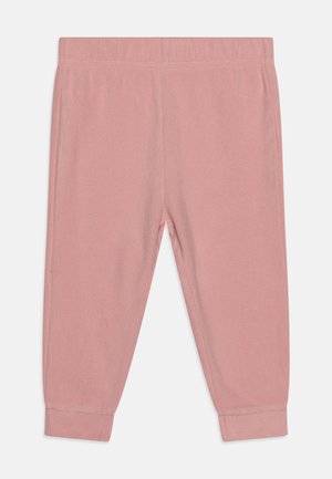Ružové teplákové nohavice vyrobené z jemnej látky. Majú elastický pás, zúžené manžety a hladkú textúru. Jednoduchý dizajn bez vzorov.