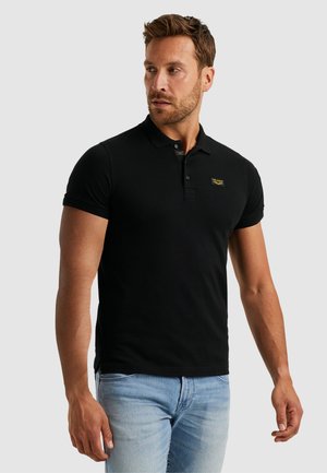 Black polo shirt made of cotton, featuring a three-button placket, short sleeves, and a small logo on the chest. Designed with a slim fit.