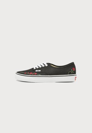 Black Vans sneaker with white laces, white sole, and red rose embroidery on the side and near the toe.