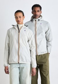 Light gray jackets with hoods, featuring contrasting vertical stripes, zip closures, and elastic cuffs. Casual fit with a smooth texture.