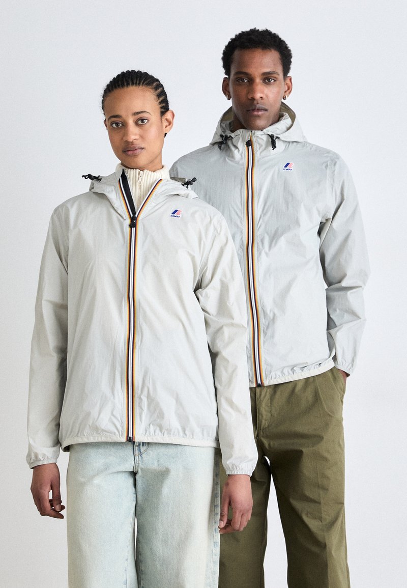 Light gray jackets with hoods, featuring contrasting vertical stripes, zip closures, and elastic cuffs. Casual fit with a smooth texture.