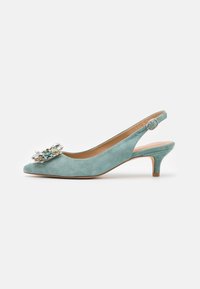 Světle modré semišové slingback boty na kitten podpatku se stříbrnou přezkou a dekorativními květinovými a krystalovými ozdobami na špičaté špičce.
