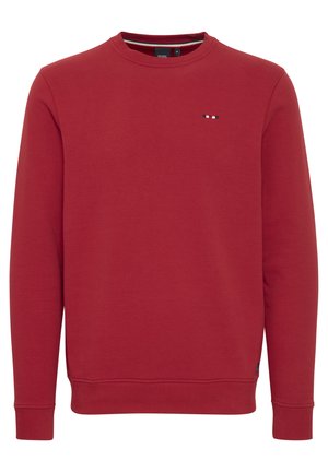 Hanorac roșu dintr-un amestec moale de bumbac, cu guler rotund, mâneci lungi și un mic logo brodat în culori contrastante pe piept.