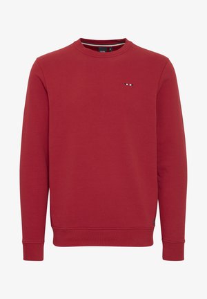Punane sviiter, mis on valmistatud pehmest puuvilla segust, millel on ümmargune kaelus, pikad varrukad ja rindkere kohal väike kontrastsetes värvides tikandiga logo.