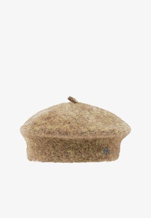 Soft fuzzy beige beret with a small top stem and a round metal logo on the side against a white background.