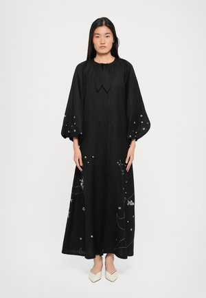 Black long-sleeve dress with a round neckline, featuring colorful star embroidery and balloon sleeves. Flowing silhouette and textured fabric.
