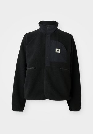 Fekete bolyhos dzseki magas gallérral, patentgombokkal, cipzáras zsebekkel, és egy kontrasztos mellzsekkel, amelyen a Carhartt logó patch található.