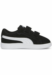 Zapato de ante negro con acentos blancos, que presenta un diseño de bajo y dos correas de velcro. Suela de goma blanca y parte superior texturizada.