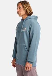 Blue cotton hoodie with a front pocket, drawstring hood, and printed logo detailing. Smooth texture, casual fit, and long sleeves.