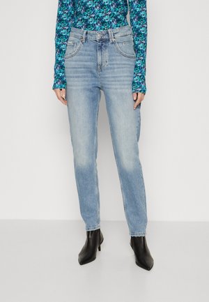 Straight light blue jeans worn with a blue floral long-sleeve top and black pointed ankle boots on a white background.