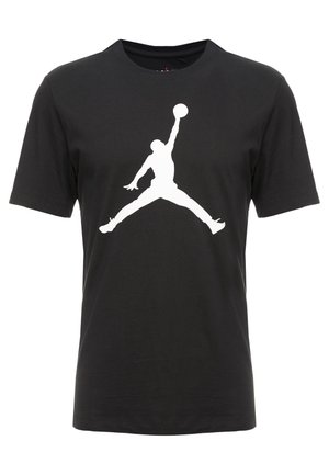 Camiseta de algodón negra con un gran logo Jumpman blanco en el delantero. Diseño de mangas cortas y cuello redondo.
