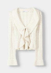 Cardigan tricoté couleur crème avec un large col, une fermeture à nouer et un motif texturé. Longueur cropped et manches à bords évasés.
