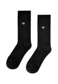 Czarne bawełniane skarpetki typu crew z prążkowanym mankietem, gładką teksturą i małym białym logo z boku. Standardowy kształt skarpet.