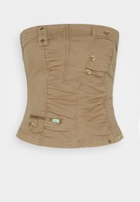 Brun utan axelremmar topp med textur av samlad tyg, knappelement och en dragkedjeficka på sidan. Tillverkad av lättviktsmaterial.