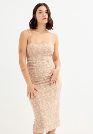 Vestido midi en beig con patrón floral, tirantes ajustables y silueta ajustada. Tela suave y ligera.