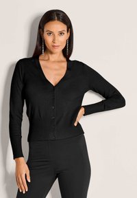 Schwarzer Cardigan mit V-Ausschnitt, langen Ärmeln, gerippten Bündchen und Taillenbund, mit Knopfverschluss vorne. Weicher, strukturierter Stoff.