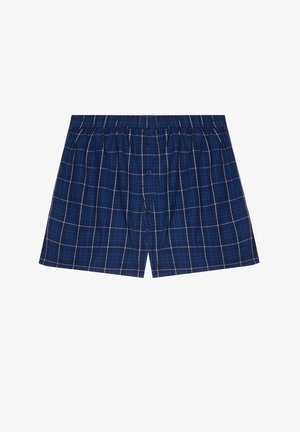 Boxer in flanella a scacchi blu navy con un morbido tessuto, caratterizzati da un motivo a griglia bianca, una vita elastica e due bottoni frontali.