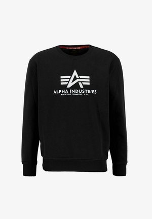 Mustapaita, jossa on pyöreä kaula-aukko, ja jonka keskellä on valkoinen graafinen logo ja teksti "Alpha Industries Knoxville, Tennessee, U.S.A.".