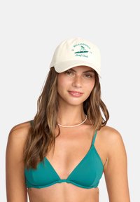 Crème corduroy baseballcap met groen geborduurd "Billabong Surf Club" logo. Gebogen rand en verstelbare strap aan de achterkant.