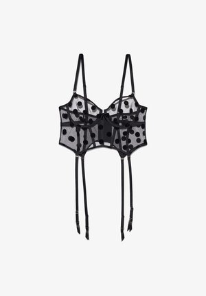 Black mesh bra with large black polka dots. Features underwire, adjustable straps, and four garter straps with metal hardware.