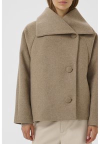 Collared beige wool coat with a relaxed fit, featuring three large round buttons and a textured fabric.