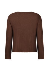 Bruine geribbelde lange mouw top met een relaxte pasvorm. Heeft een ronde halslijn en een zoom die op de heupen valt. Zachte textuur.