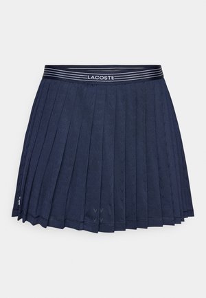 Gonna plissettata blu navy con fascia in vita a righe che presenta il nome del marchio. Tessuto morbido con motivi geometrici su tutta la superficie.