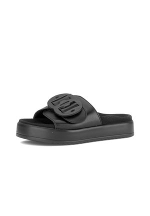 Black open-toe slide sandal with thick sole and wide strap featuring a large decorative buckle on top.