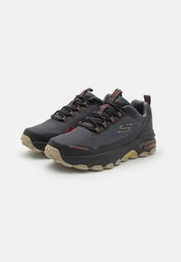 Black waterproof sneakers with a textured upper, contrasting red accents, sturdy outsole, and a padded collar for comfort.