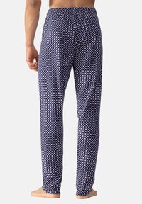 Textiele pyjamabroek met een marineblauwe basis en een klein wit en rood bloemenpatroon, met een relaxte pasvorm en een elastische tailleband.