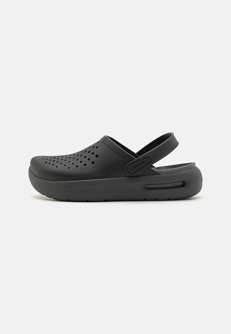 Black clog made of lightweight material with ventilation holes, rounded toe, adjustable heel strap, and textured sole for grip.
