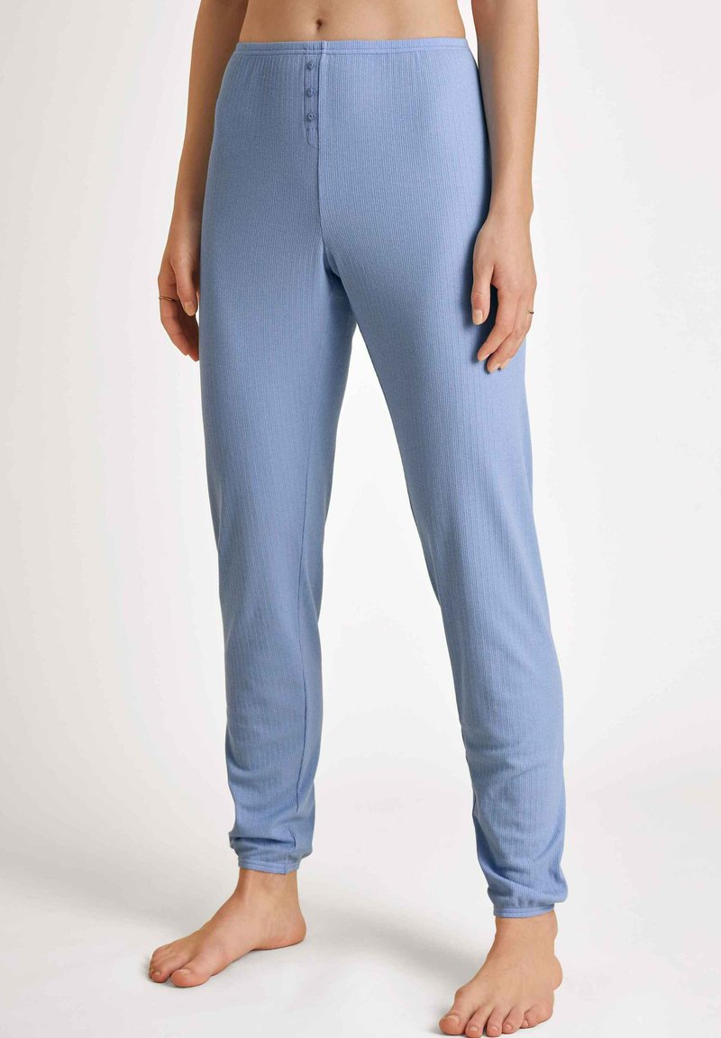 Lichtblauwe, geribbelde loungebroek met een aansluitend ontwerp, voorzien van een knoopsluiting bij de tailleband en taps toelopende manchetten. Zachte materiaalkwaliteit.